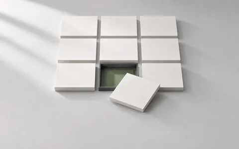 An array of paper tiles with one displaced tile, illustrating a failing test to repair.